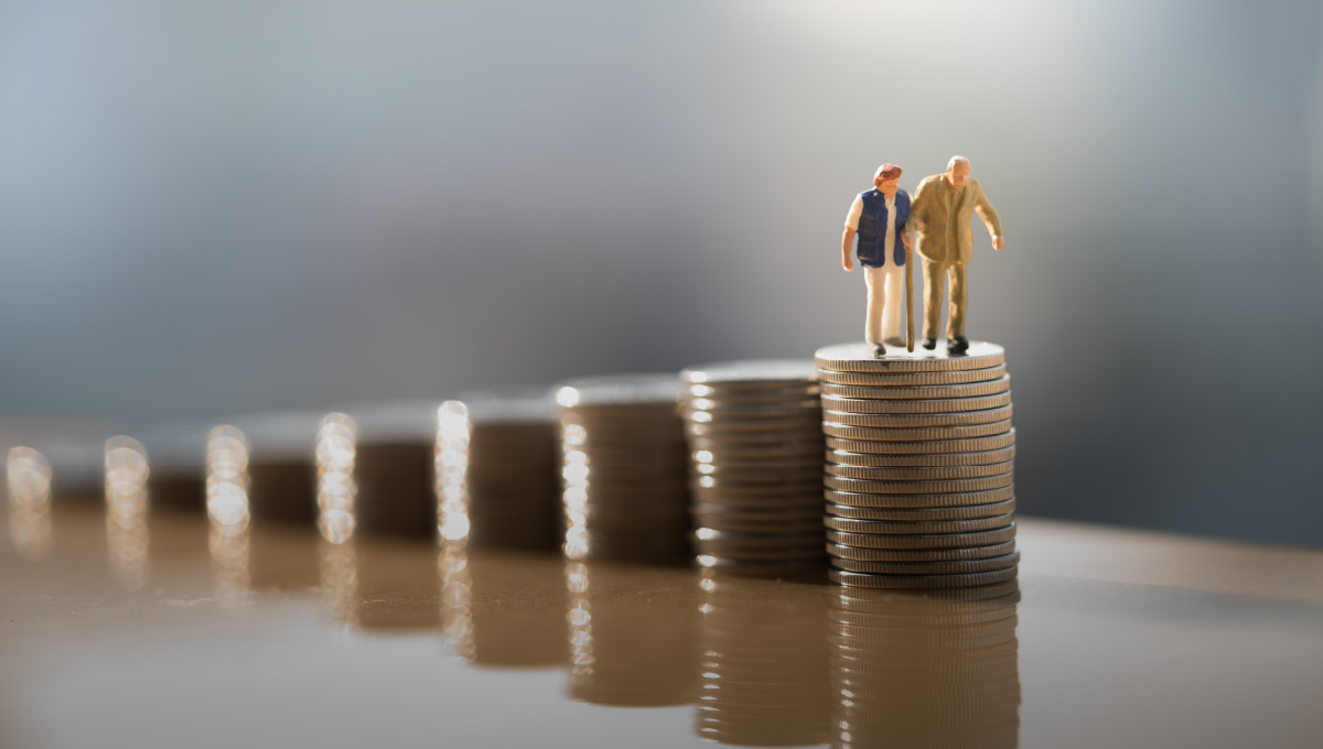 Retirement savings through Traditional and Roth IRAs depicted by an elderly couple standing on a stack of coins.