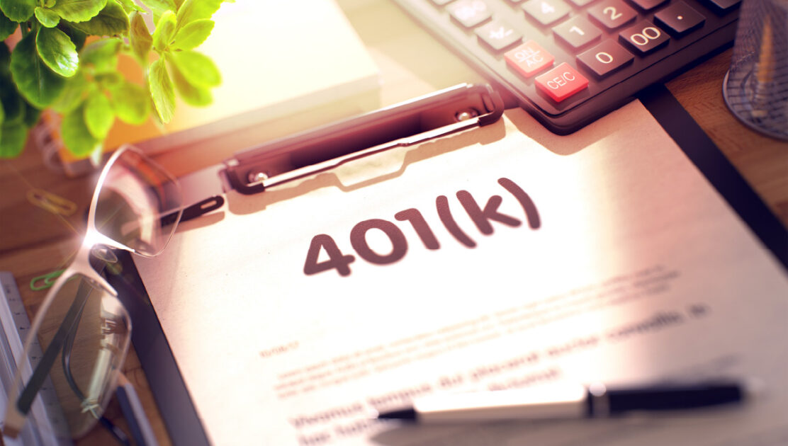 401k written on a sheet of paper on a clipboard.