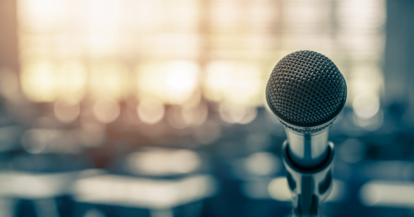 A microphone sitting in front of an auditorium.