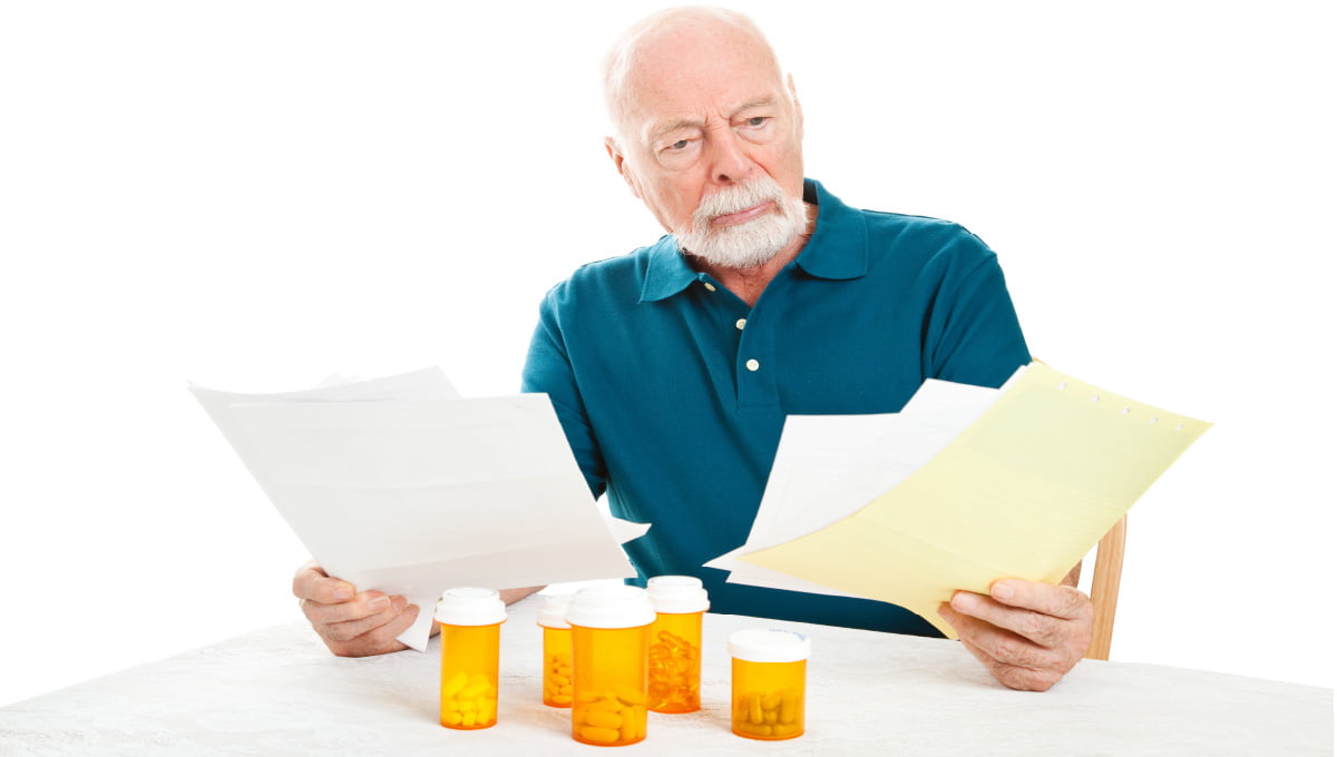 A senior man looking at medical bills.