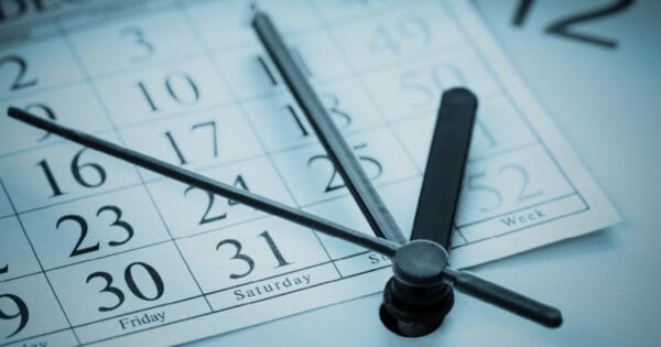 A December calendar with the face of a clock overlaid