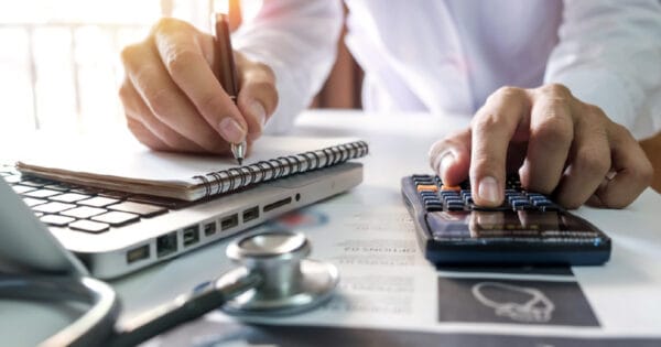 A person comparing Medigap plan costs with a calculator